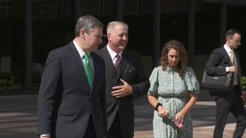 Pro-life activist Mark Houck, second from left, outside court