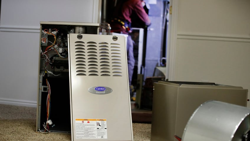 The Biden-Harris administration is pushing regulations that would make all sorts of appliances more expensive, like furnaces. FILE: A new Carrier natural gas furnace at a residential home in Spanish Fork, Utah, U.S., on Tuesday, Oct. 19, 2021.