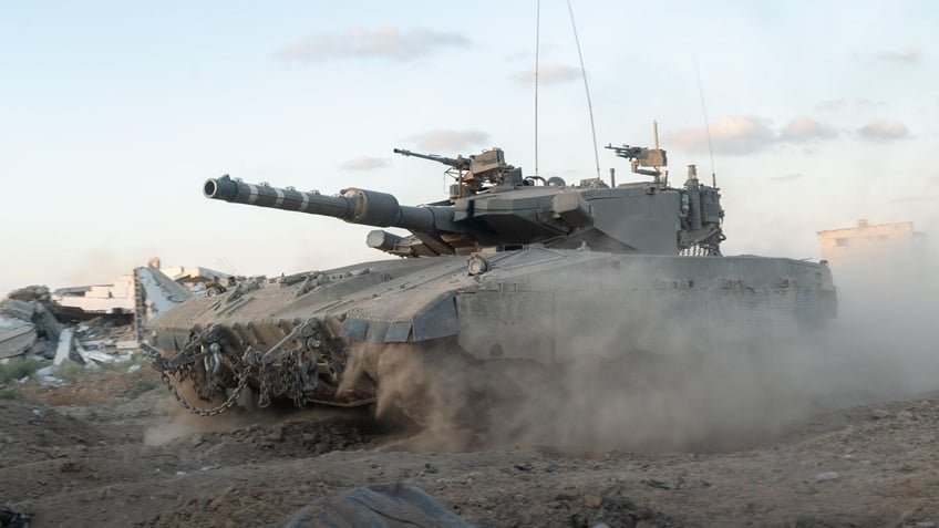 An Israel Defense Forces tank rolls through the Netzarim Corridor in Gaza.