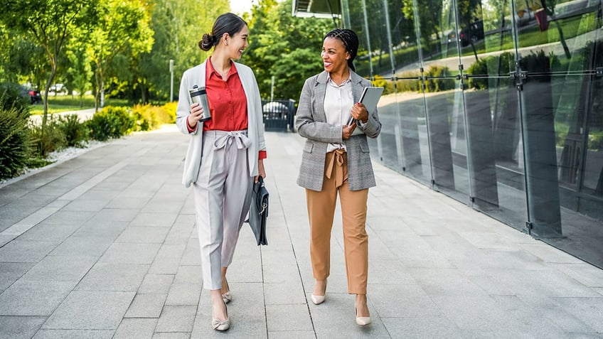 Two women walking at work