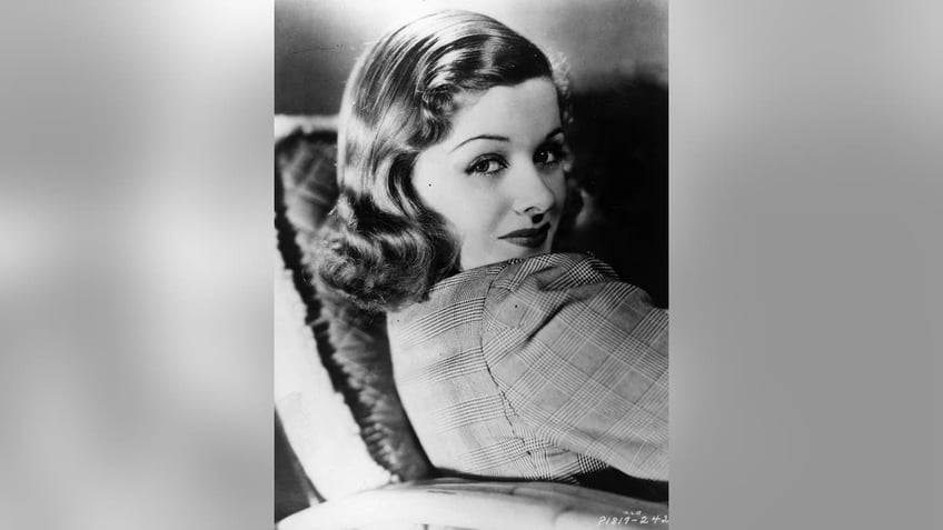 Joan Bennett looking to the side in a coy and glamorous way