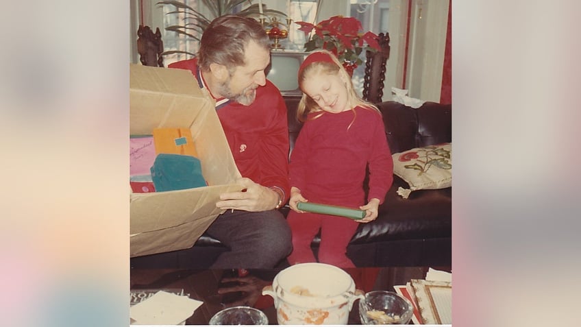 Victoria Price opening up presents with her dad