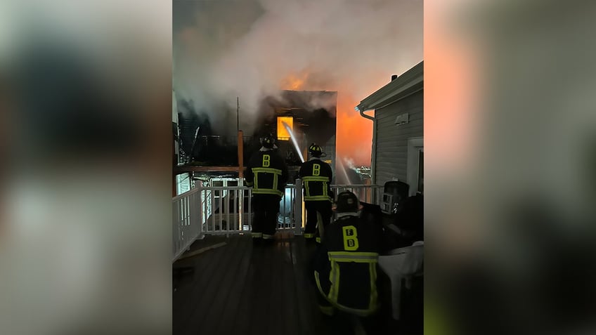 Firefighters work to put out flames