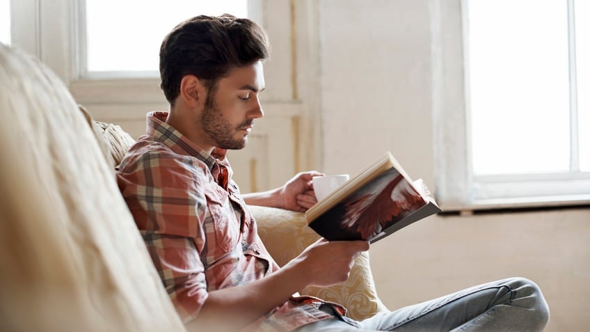 Man reading on couch