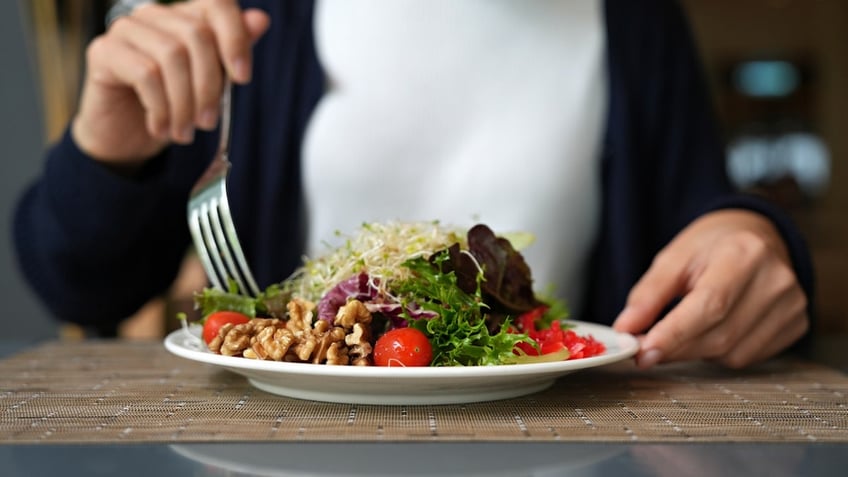 Woman eating salad