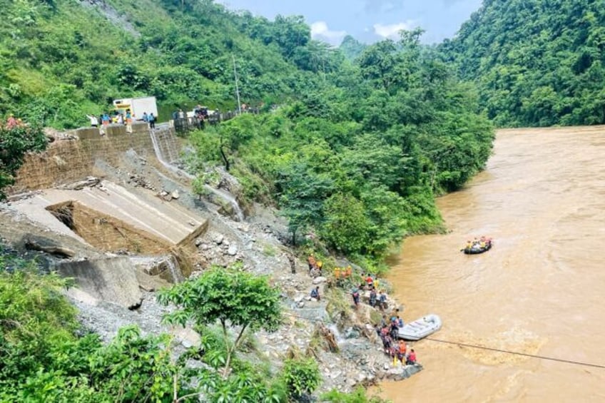 Rescuers search for survivors in the river Trishuli in Simaltar after a landslide triggere