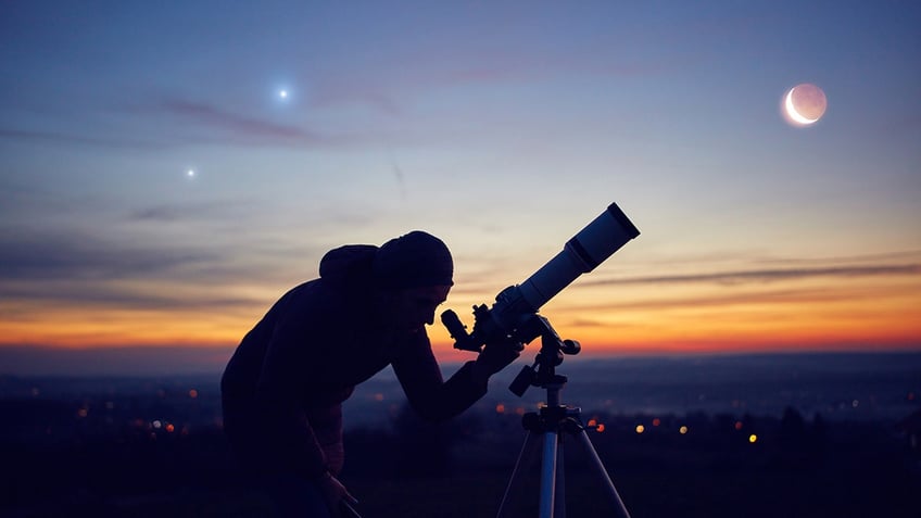 woman gazing into telescope