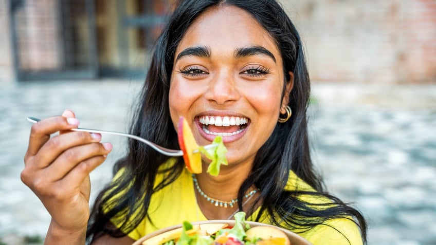 woman eating salad