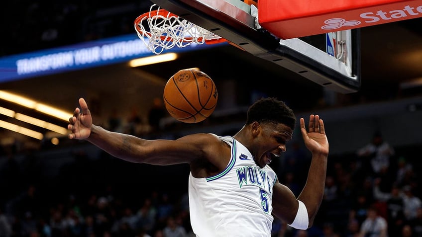 Anthony Edwards celebrates a dunk