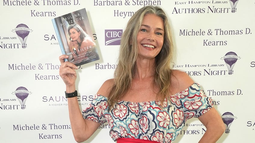 Paulina Porizkova with a copy of her book.