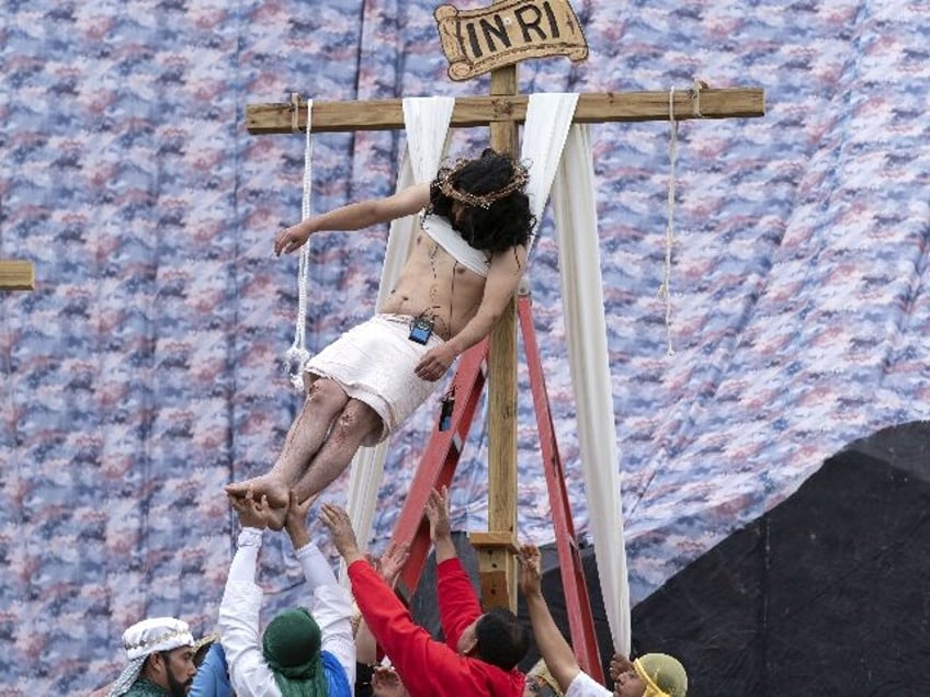 Juan Carlos Rosas, performs as Jesus Christ during a Good Friday re-enactment of the cruci