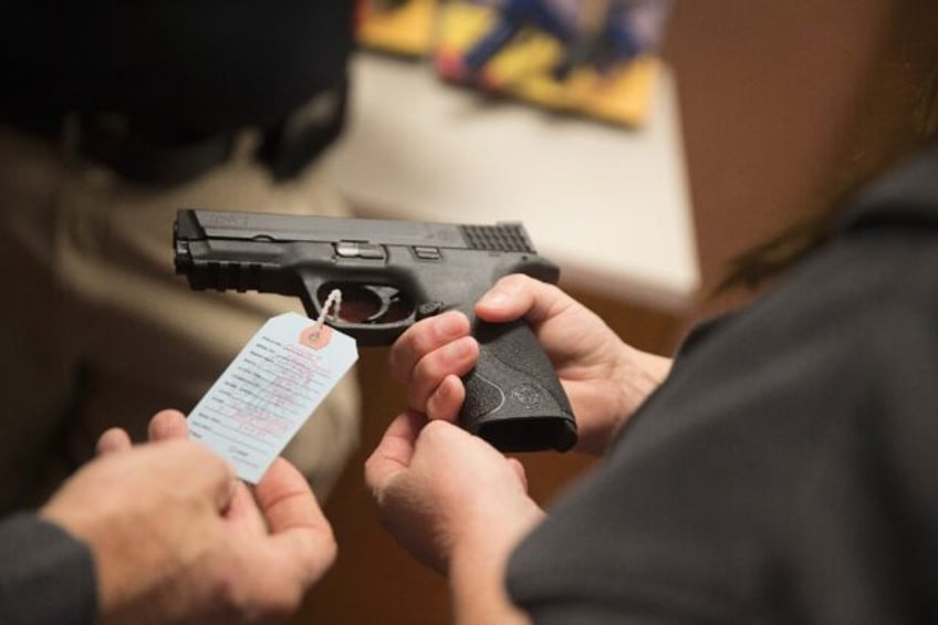 Customers shop for a handgun in Bridgeton, Missouri in November 2014