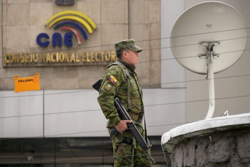 A soldier stands guard outside the National Electoral Council (CNE) in Quito on February 7