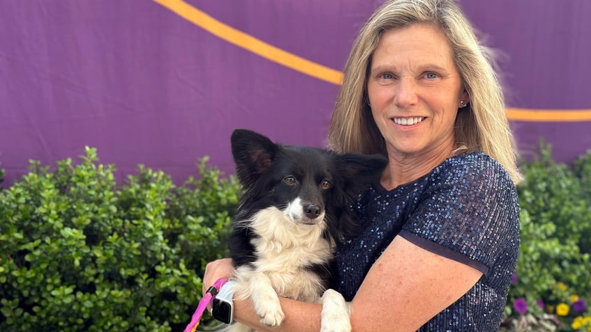 Cynthia Hornor poses with Nimble, the first mixed-breed dog ever to win the Westminster Kennel Club dog show's agility competition