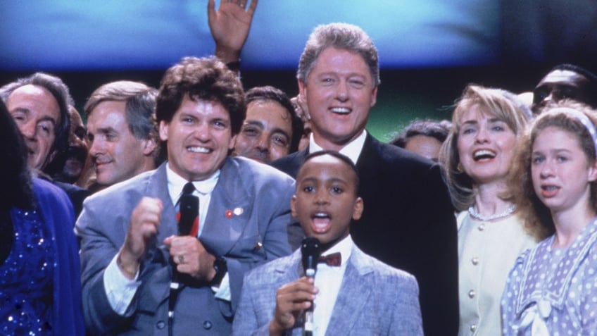 Then-Democratic presidential candidate Bill Clinton and his half-brother, Roger, with a group of supporters, on July 16, 1992.