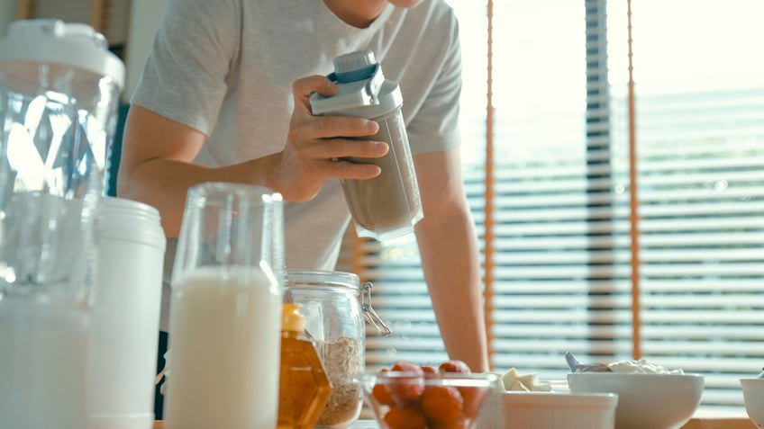 Person using shaker bottle