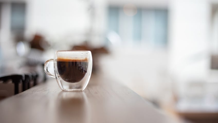 A clear glass espresso cup