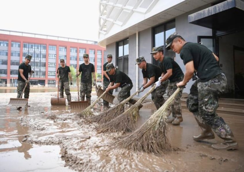 a mudslide kills at least 2 in china while rain from khanun cancels some trains in the northeast