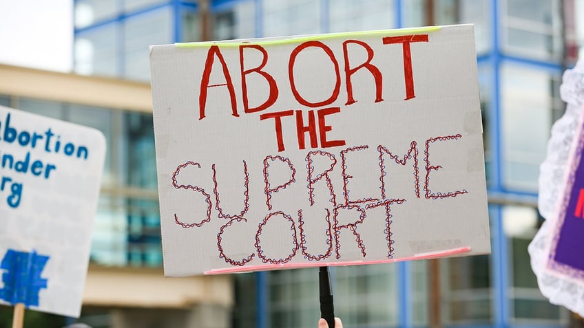 Abortion rights demonstrators gather near the Hubert H. Humphrey School of Public Affairs at the University of Minnesota in Minneapolis, Minnesota