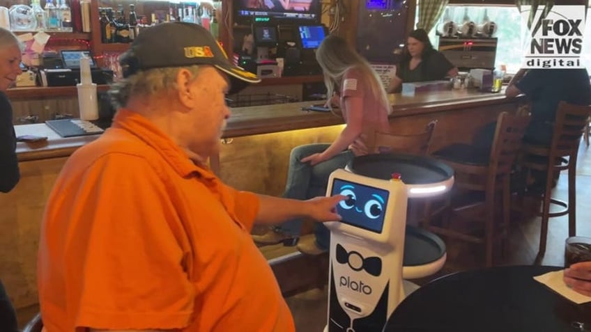 a struggling restaurant owner hired a robot to help her servers then the angry messages began