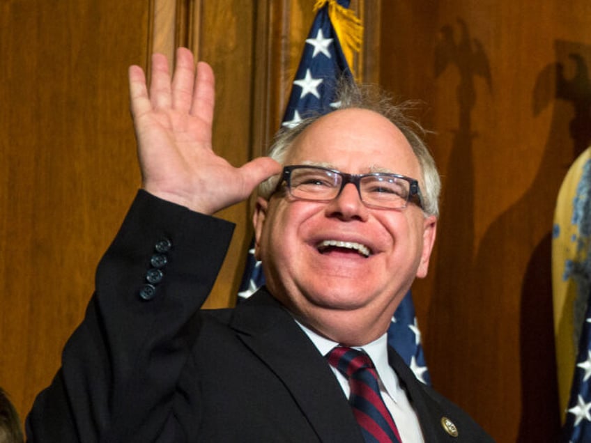 In this Jan. 3, 2017, file photo, U.S. Rep. Tim Walz, D-Minn., waves during his mock swear