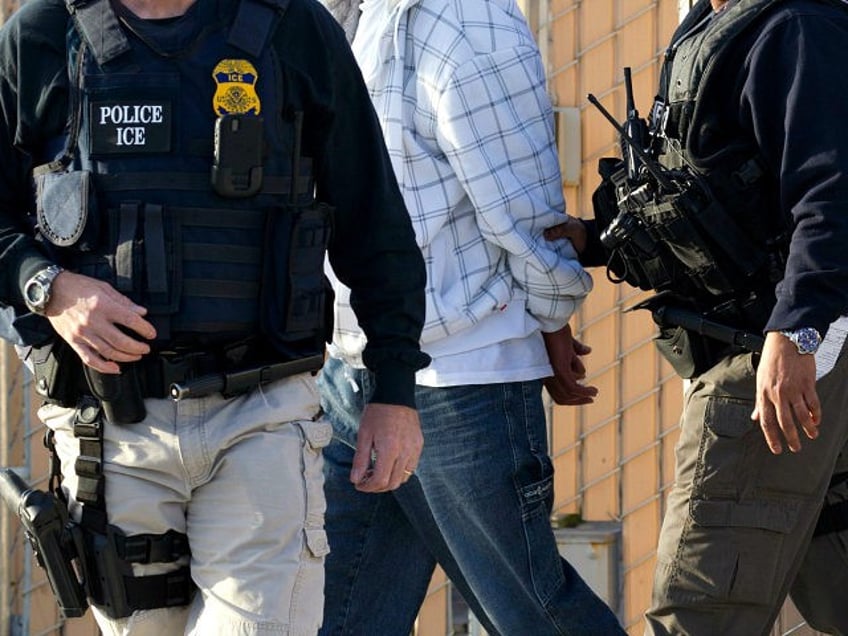 In this March 30, 2012 photo, Immigration and Customs Enforcement (ICE) agents take a susp