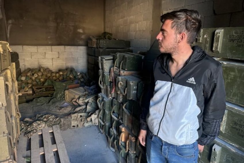 A Syrian man inspects an apparent weapons depot in the Sayyida Zeinab suburb of Damascus