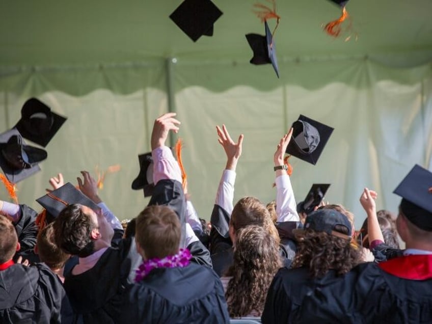 Grads throwing mortarboards in the air