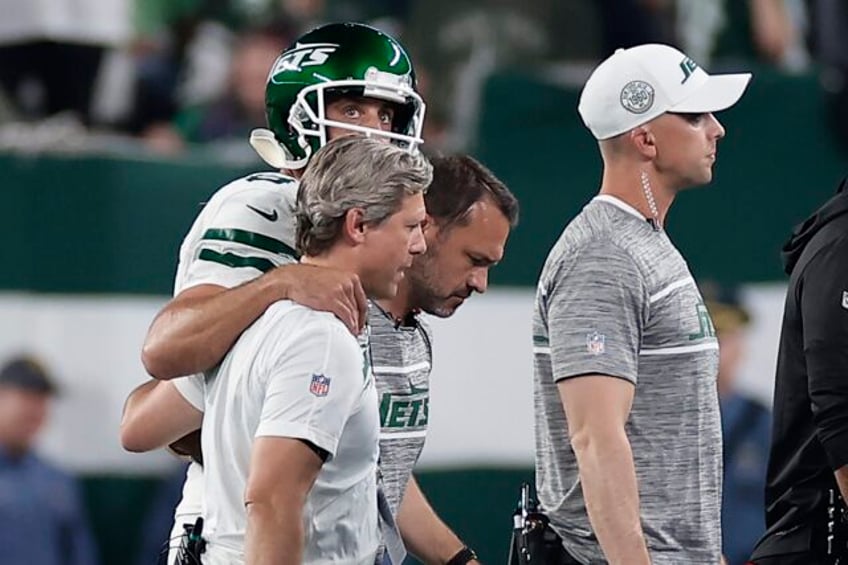 aaron rodgers hurts ankle in first series for jets is carted off sideline and ruled out of game