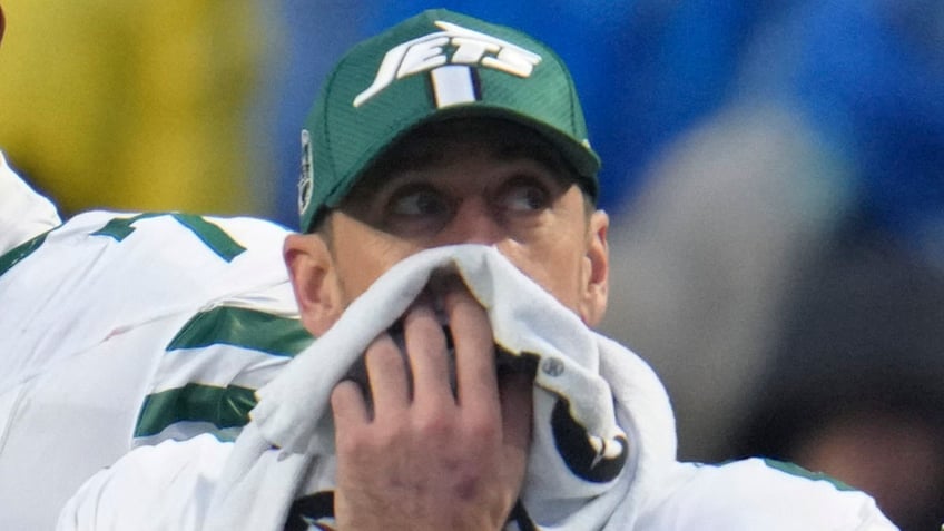 Aaron Rodgers covers his face