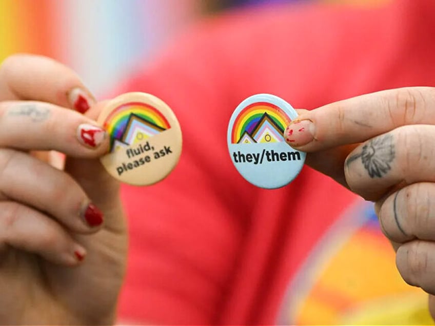 Laramie LGBTQ residen and University of Wyoming Alumni Ray Kasckow holds pins about gender