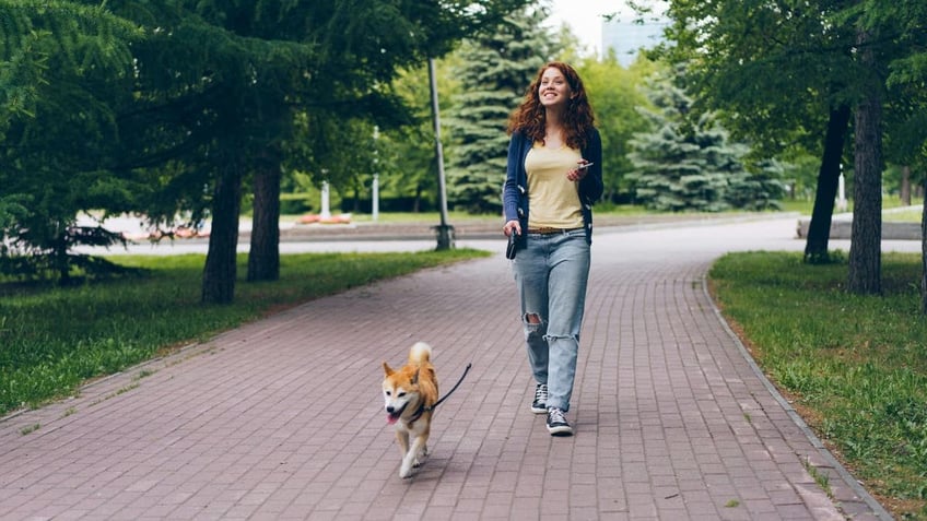 woman walking dog