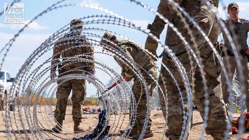 Razor wire and border patrol agents