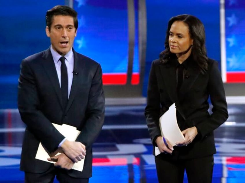 ABC World News Tonight Anchor David Muir, left, addresses members of the audience while st