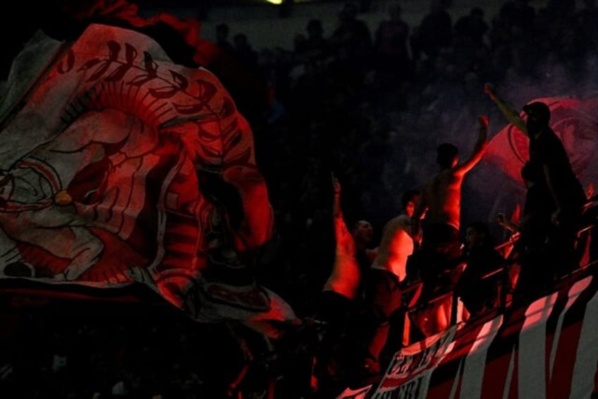 AC Milan's ultras fans celebrate during a Serie A match against Lecce at the San Siro stad