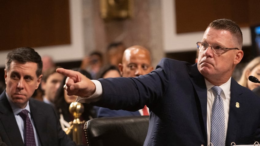 U.S. Secret Service Director Ronald Rowe Jr. points toward a photograph during a Senate hearing on the Trump assassination attempt