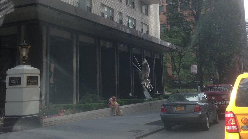 Otto Warmbier sitting outside of a Manhattan apartment building