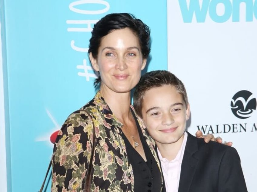 WESTWOOD, CA - NOVEMBER 14: Carrie-Anne Moss and her son, Jaden Roy arrive to the Los Ange