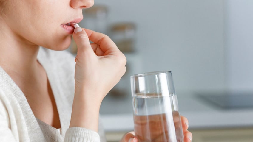 Woman taking pill