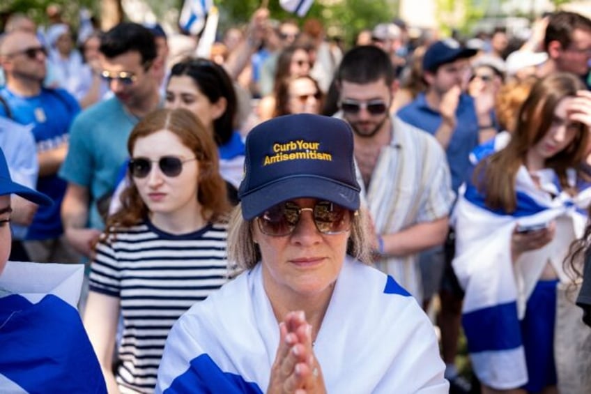 A woman wears a hat that reads "Curb Your Antisemitism" during a rally against campus anti