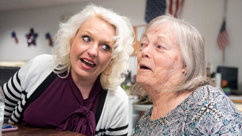 VNA Caring Center Director Angela Loeper, left, sings an oldies tune with client Marilyn Vargo.