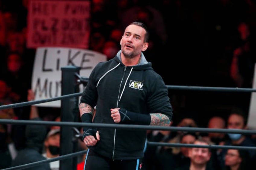 aew star cm punk holds trans tights are human rights sign at wembley stadium