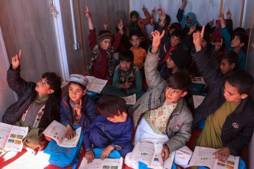 Children attend class in a shipping container in Nayeb Rafi village in western Afghanistan