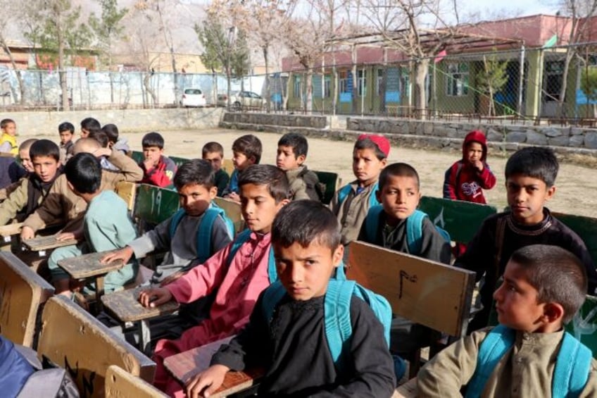 Afghan school boys attend their first class following the start of the new academic year,