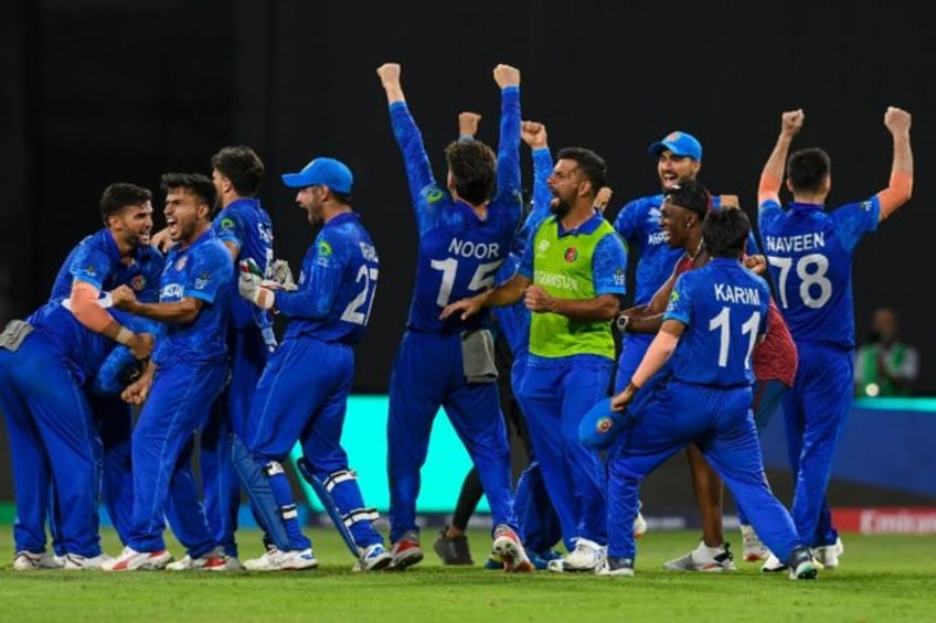 Afghanistan's players celebrate victory over Bangladesh at the T20 World Cup which sealed