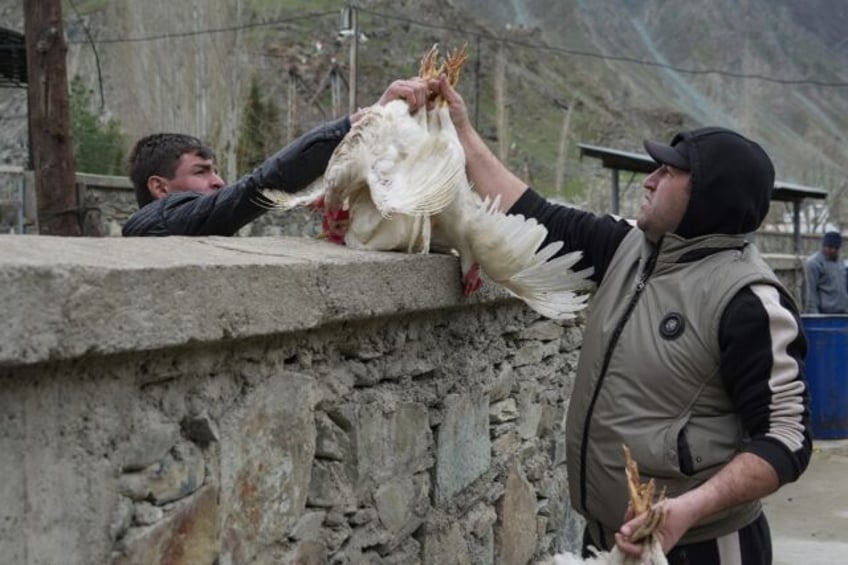 Tajiks and Afghans buy and sell at a bazaar in the Tajik town of Kalai-Khumb on the border