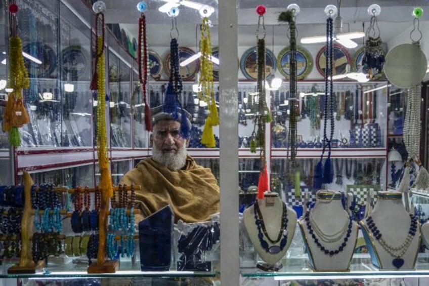 An Afghan jeweller waits for customers in his empty shop in Kabul, where residents have co