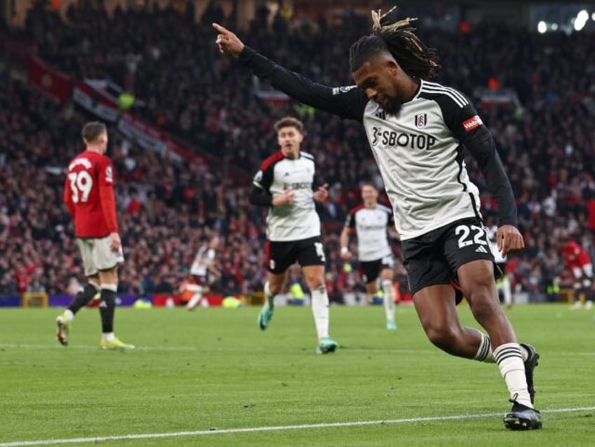 Alex Iwobi (R) celebrates scoring Premier League winner for Fulham at Manchester United.