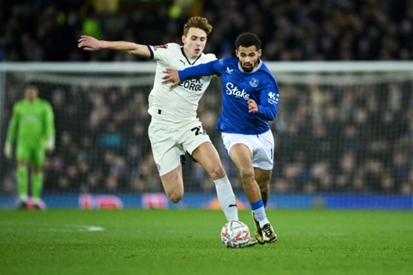 Everton forward Iliman Ndiaye (R) holds off a Peterborough United opponent during an FA Cu