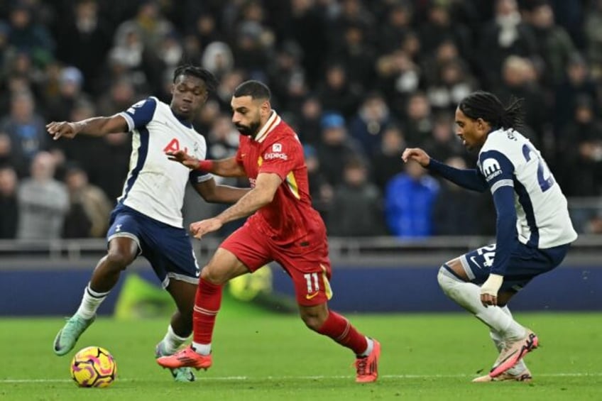 Liverpool star Mohamed Salah (C) bursts between Yves Bissouma (L) and Djed Spence of Tott